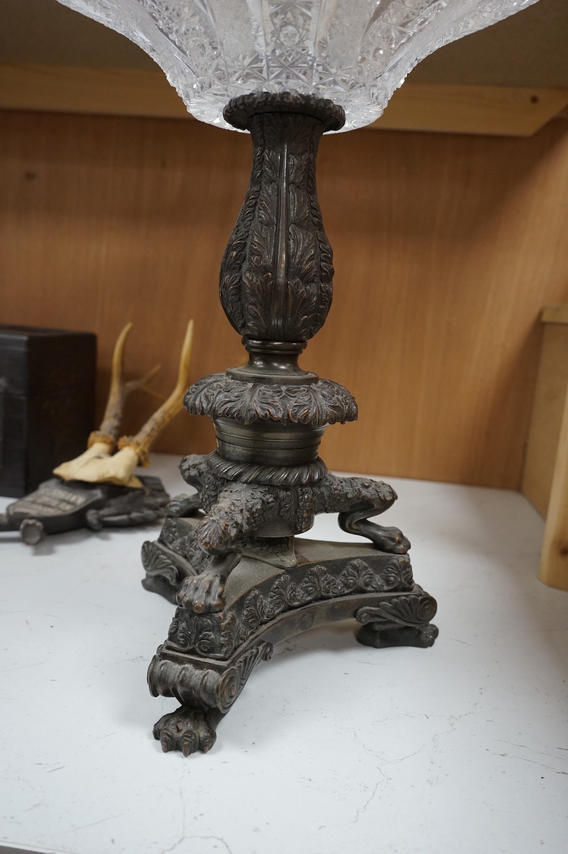 A large cut glass tazza, on bronze tri-form pedestal base, 39cm high.